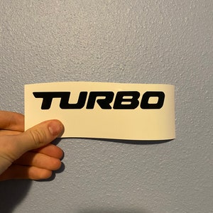 May include: A white sticker with the word "TURBO" printed in black letters.