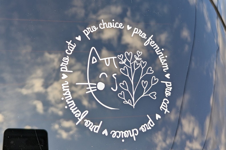 May include: White vinyl sticker with a cat illustration and the text "pro choice &hearts; pro feminism &hearts; pro cat &hearts; pro choice &hearts; pro feminism &hearts; pro cat" in a circle.
