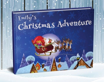 May include: A hardback book titled Emily's Christmas Adventure with a dark blue cover featuring a white snowflake pattern. The illustration shows Santa Claus in a red sleigh pulled by reindeer over a snow-covered village under a full moon.