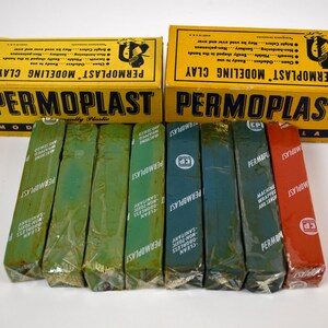May include: A set of eight modeling clay sticks in various colors, including green, blue, and red. The sticks are wrapped in plastic and labeled "PERMOPLAST" with the text "MODELING CLAY" on the yellow boxes.