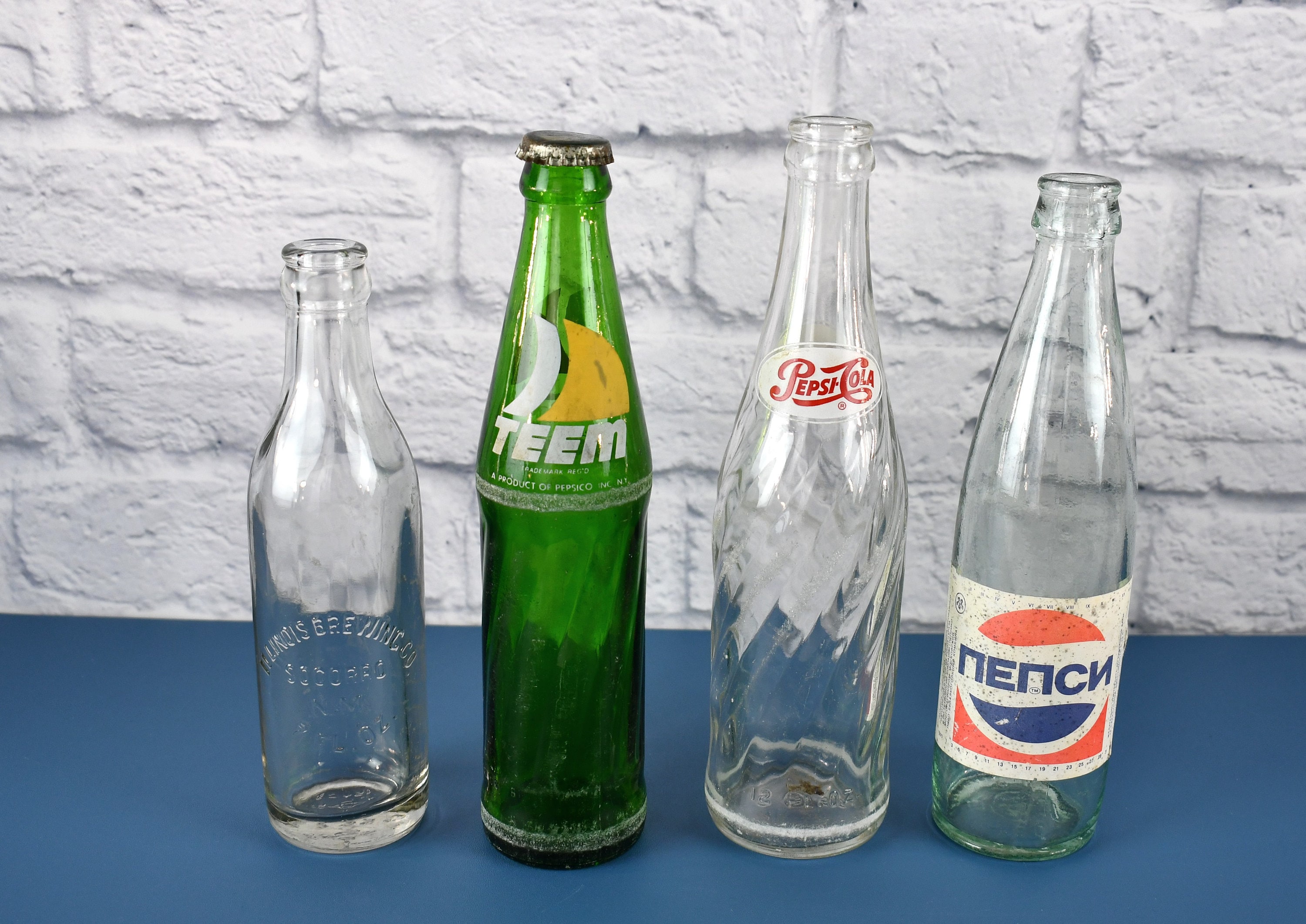 Vintage Soda Bottles Pepsicola, Teem in Arabic, Pepsi in Russian & Illinois Brewing Company