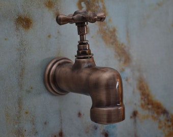 May include: A vintage-style copper faucet with a cross-shaped handle. The faucet is mounted on a rusty metal wall.