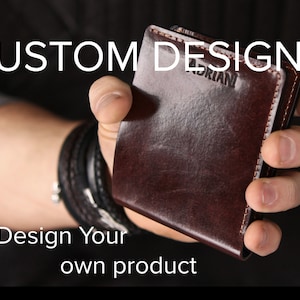 May include: A dark brown leather wallet featuring visible stitching along the edges and the embossed name ADRIAN. The text CUSTOM DESIGN and Design Your own product are overlaid on the image of the wallet held in a hand.