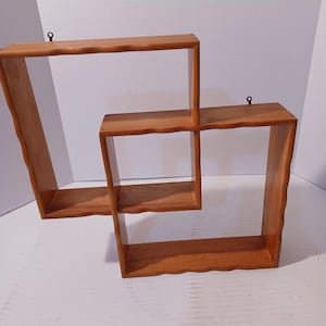 May include: A handmade wooden sign with the text "Welcome" in a playful font. The sign features a distressed white background and a dark brown border, perfect for a front door or entryway. The sign measures approximately 12 inches wide and 6 inches tall.