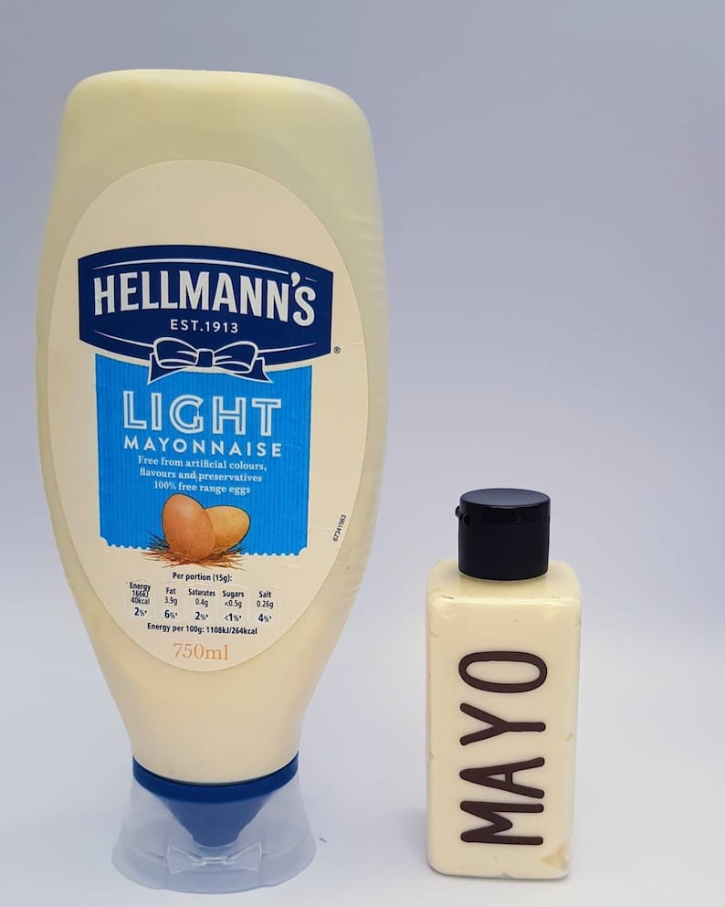 May include: Two bottles of mayonnaise, one large and one small. The large bottle is labeled "Hellmann's Light Mayonnaise" and is 750 ml. The small bottle is labeled "MAYO".