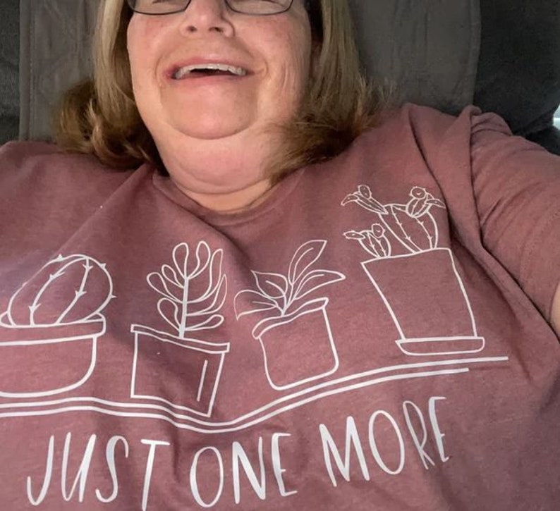 Show off your plant passion with our "Just One More" Cactus and Succulent Graphic T-Shirt! Designed for those who can never have too many plants, this tee is a fun nod to the joy of gardening.