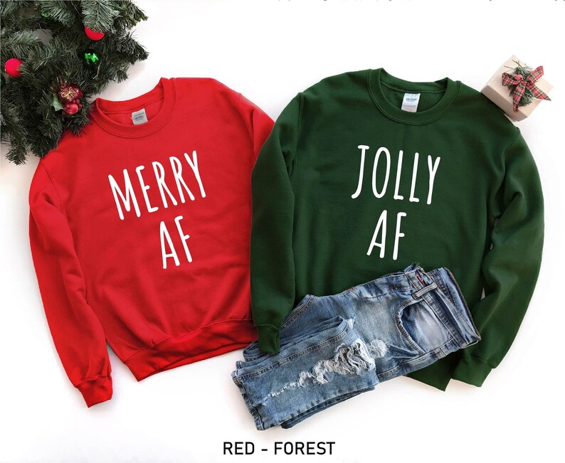 May include: Two Christmas themed sweatshirts, one red with the text "Merry AF" and one green with the text "Jolly AF".