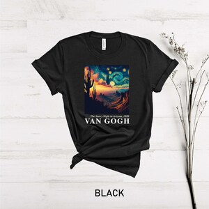 May include: Black t-shirt with a graphic print of a starry night sky with a desert landscape and the text "The Starry Night in Arizona, 1889" and "VAN GOGH".