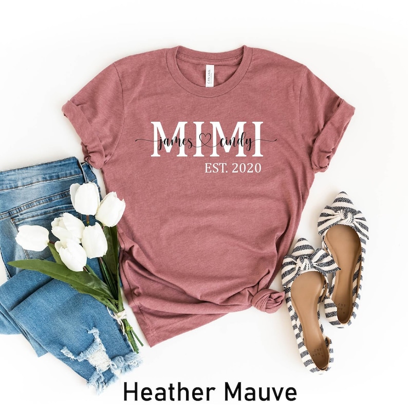 May include: Heather mauve t-shirt with the text "MIMI James &hearts; Cindy EST. 2020" printed on the front.