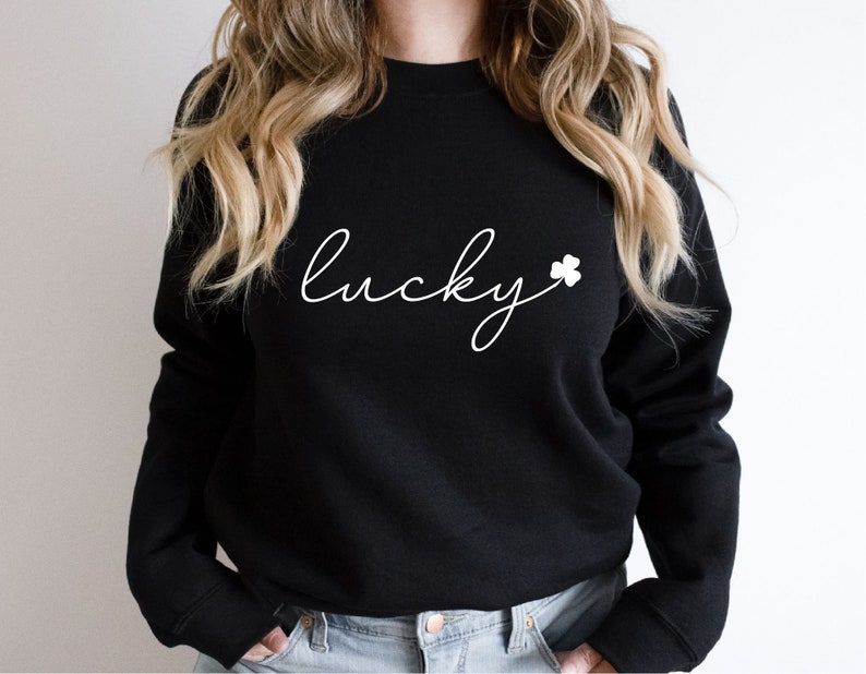 May include: Black sweatshirt with white text that says "lucky" with a white shamrock.