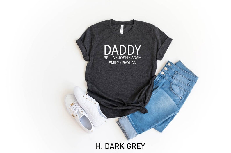 May include: Dark grey t-shirt with the text "Daddy" and the names "Bella, Josh, Adam, Emily, Raylan" printed in white.