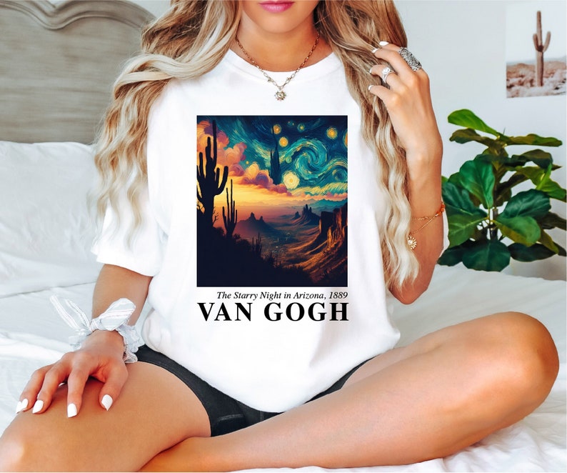 May include: White t-shirt with a graphic print of a starry night sky with a desert landscape and the text "The Starry Night in Arizona, 1889 VAN GOGH".