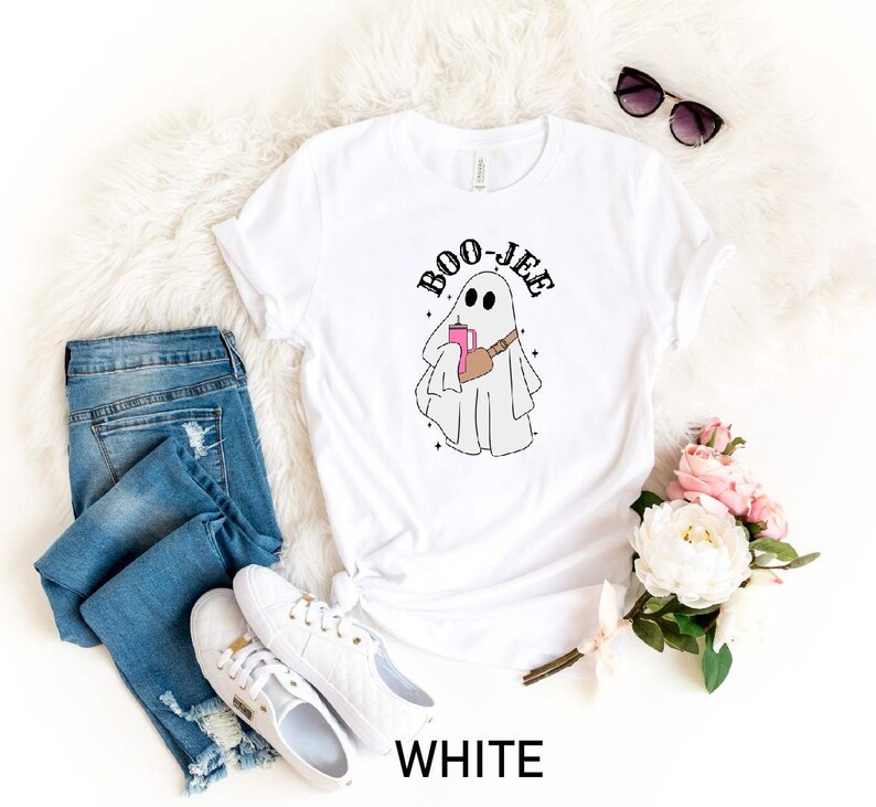 May include: White t-shirt with a ghost holding a pink drink and the text "BOO-JEE" printed on it.