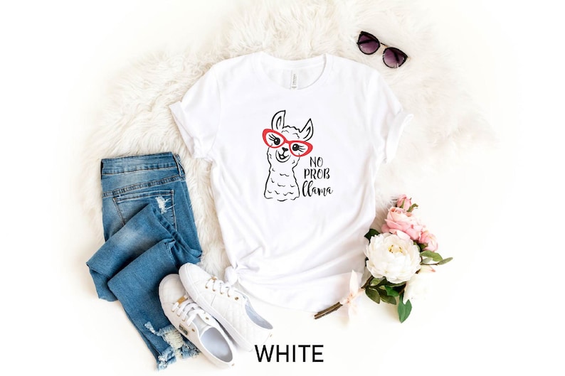 May include: White t-shirt with a cartoon llama wearing red sunglasses and the text "No Prob Llama".