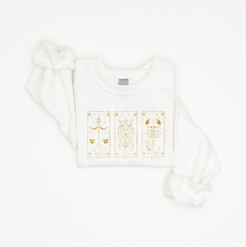 Featuring captivating tarot card graphics, this Astrology Tarot Card Graphic Tee is a must-have for fans of celestial zodiac symbolism.