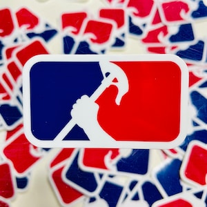 May include: A white sticker with a red and blue baseball-style logo. The logo features a white silhouette of a hand holding a pickaxe.
