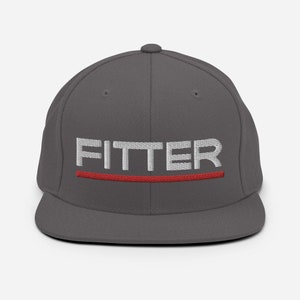 May include: A charcoal gray fitted baseball cap with a white embroidered word "FITTER" and a red stripe underneath.