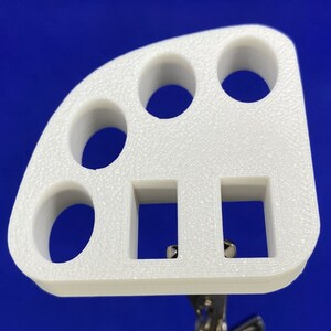 May include: White plastic organizer with multiple round and rectangular compartments.