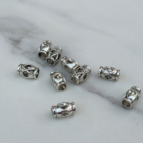 4 Tube perles ajouré en métal placage argent.