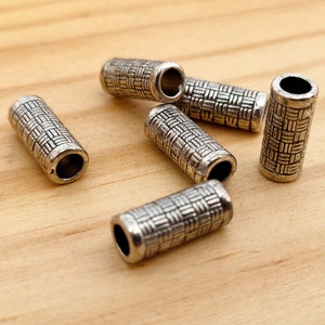 4 silver Tibetan tube beads.