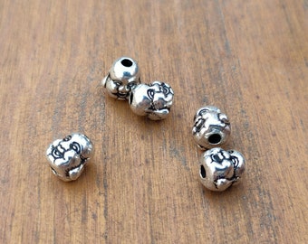 2 Buddha head loop beads in Tibetan silver metal.