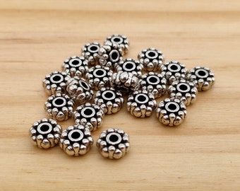 10 interlayer beads in the form of a flower in ancient silver color metal.