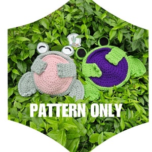 May include: Crochet pattern for two frog amigurumi toys. One frog is green with a purple belly and the other is gray with a pink belly. The pattern is for sale, not the finished toys. "PATTERN ONLY" is written in white text on a green background.