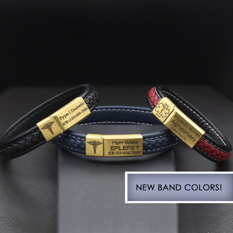 May include: Three leather bracelets with gold medical alert tags. The black bracelet says "Type 1 Diabetic ICE:(123)486-7890". The blue bracelet says "Matt White EPILEPSY ICE 123.456.7890". The red bracelet says "Ricardo Nunes Alzheimers -see back-".