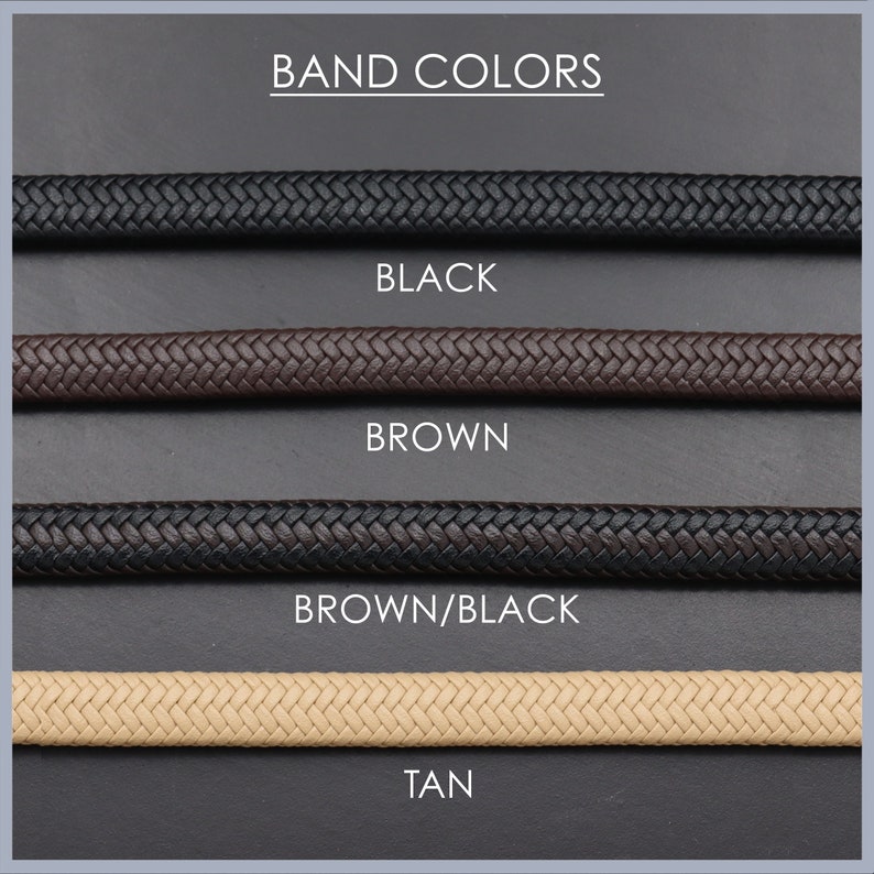 May include: Four braided watch bands in different colors: black, brown, brown/black, and tan. The bands are displayed on a gray background with the text "BAND COLORS" at the top and the color names below each band.