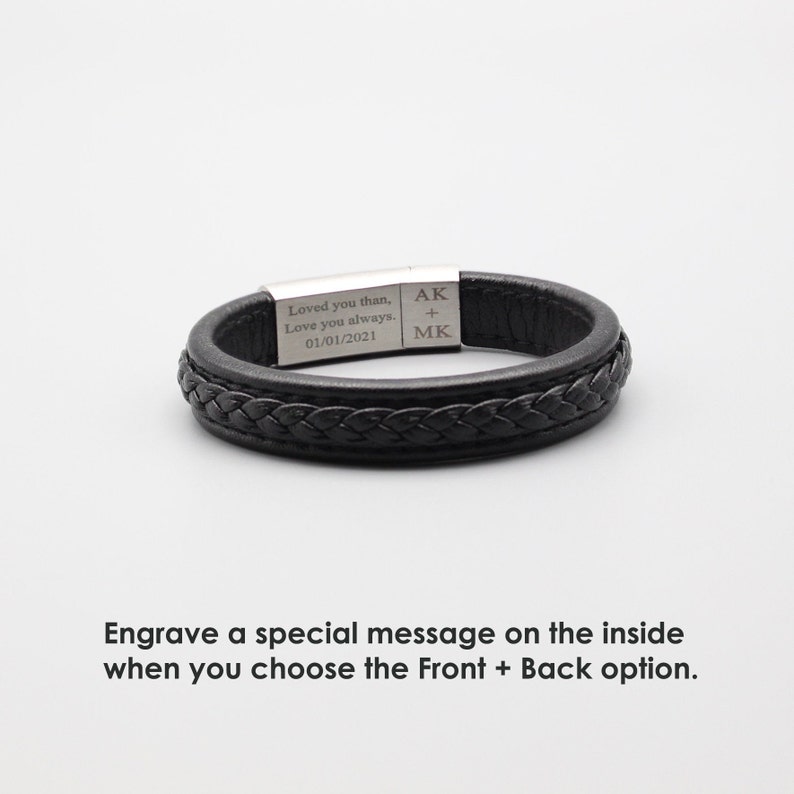 May include: Black leather bracelet with a braided design and a silver metal plate engraved with the text "Loved you than, Love you always. 01/01/2021" and the initials "AK + MK".