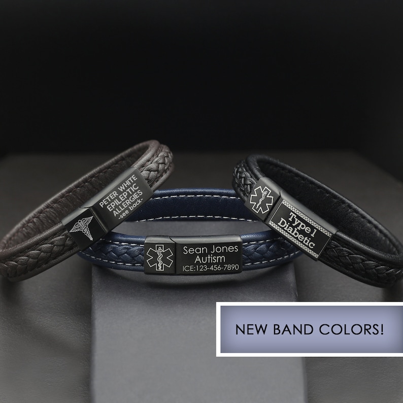 May include: Three leather bracelets with black metal plates engraved with medical information. The bracelets are brown, blue, and black. The text on the plates reads "Peter White Epileptic Allergies -see back-", "Sean Jones Autism ICE:123-456-7890", and "Type 1 Diabetic".