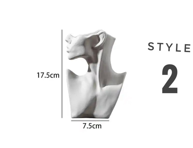 May include: White ceramic bust of a woman's neck and shoulders, used as a display stand for necklaces. The bust is 7.5 inches wide and 17.5 inches tall.  STYLE 2