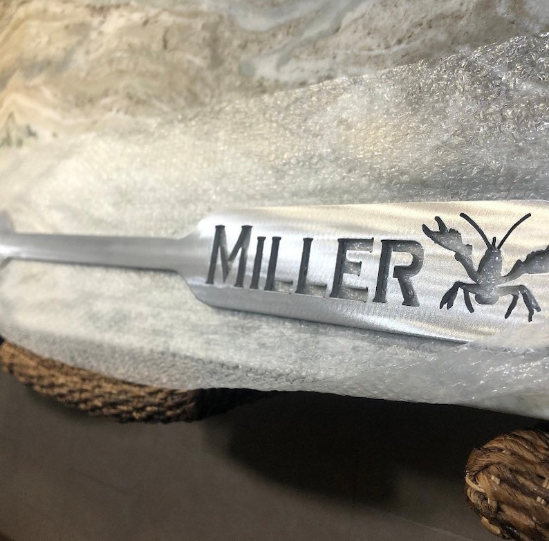 May include: A silver lobster cracker with the name "MILLER" engraved on it.