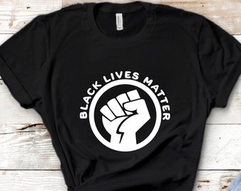 May include: Black t-shirt with a white fist raised in the air inside a circle with the text "Black Lives Matter" around it.