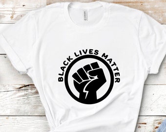 May include: White t-shirt with a black fist graphic and the text "Black Lives Matter" in a circle.