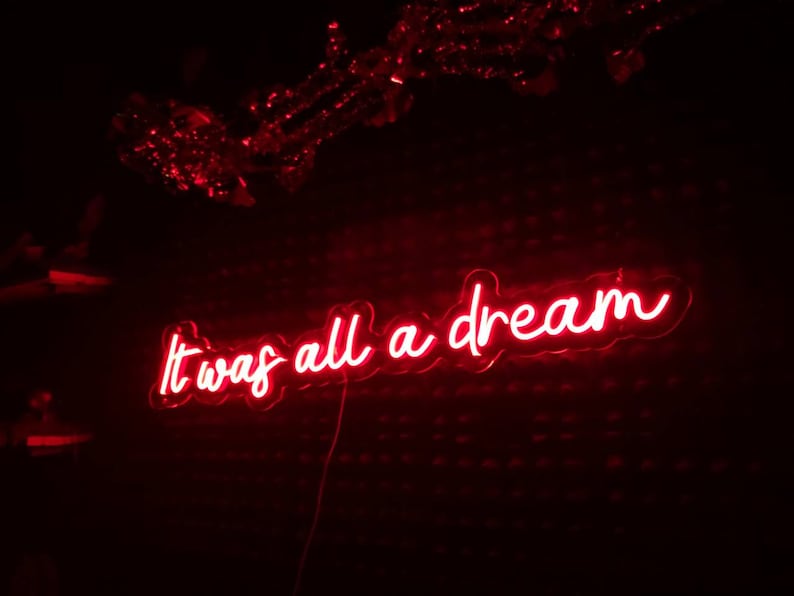 K&ouml;nnte beinhalten: Rotes Neon-Schild mit dem Text "It was all a dream" in einer kursivschrift.