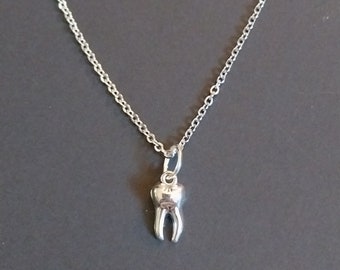 Silver tooth necklace, matching earrings available, 20 inch stainless steel chain.