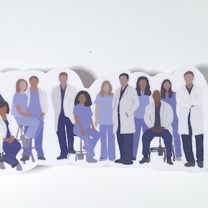 May include: A sticker featuring a group of people in medical attire. The figures are depicted in shades of blue and white, with some wearing lab coats. The sticker has a white border and a unique shape.