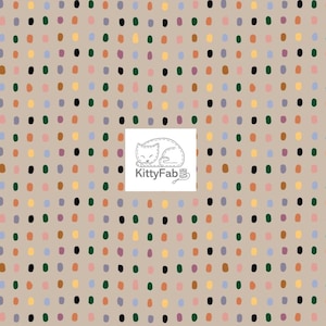 May include: Fabric with a repeating pattern of colorful, irregular dots in shades of orange, green, purple, yellow, and black on a tan background. The KittyFab logo is in the lower right corner.