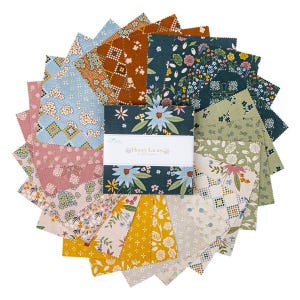 May include: A collection of fabric squares in various floral and geometric patterns. The color palette includes blues, pinks, greens, and yellows. A white label with the text "Honey Locust" is centered on the fabric squares.