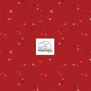May include: A deep red fabric featuring a repeating pattern of small, scattered star-like shapes in lighter pink and darker red tones. Centered on the fabric is a white square label displaying a line-art illustration of a sleeping cat and the text KittyFab.