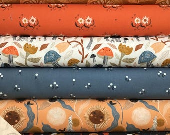 May include: A stack of fabric rolls with various nature-themed patterns. Designs include sunflowers, daisies, mushrooms, and rabbits in shades of brown, orange, blue, and white. The fabric is likely cotton or a similar material, suitable for quilting or crafting.