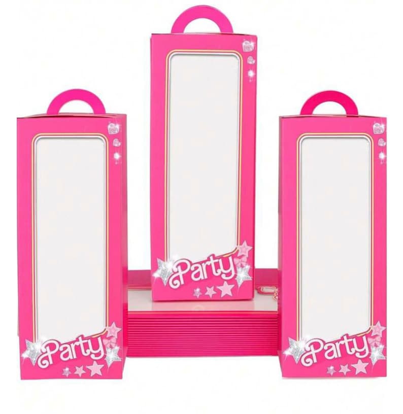 May include: Three pink party favor boxes with a clear window and a handle. The boxes have a pink and gold border and the words "Party" with stars and glitter.