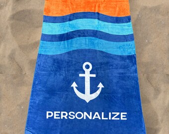 May include: A blue beach towel with a white anchor and waves. The towel has the word "PERSONALIZE" printed on it.