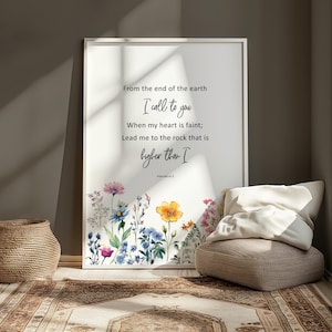 May include: Framed art print featuring a floral border with colorful flowers and the text "From the end of the earth, I call to you...higher than I." The print is displayed in a bright room with a woven basket and a patterned rug.