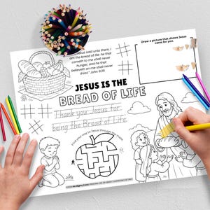 May include: A black and white coloring page with the text "JESUS IS THE BREAD OF LIFE". The page includes a basket of bread and fruit, a maze, and a drawing of Jesus with children. Colored pencils are in a container.