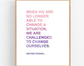 May include: A motivational quote by Viktor Frankl printed on a white background in a wooden frame. The quote reads: "When we are no longer able to change a situation, we are challenged to change ourselves."