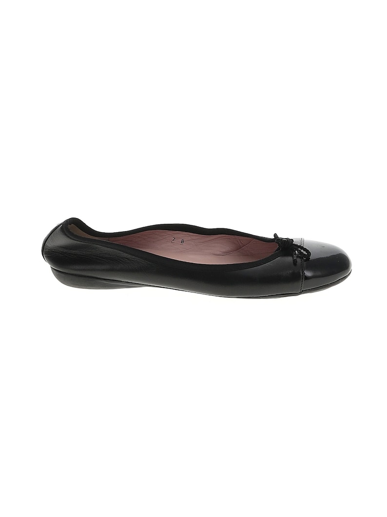 May include: Black leather ballet flats with a small bow detail on the toe.