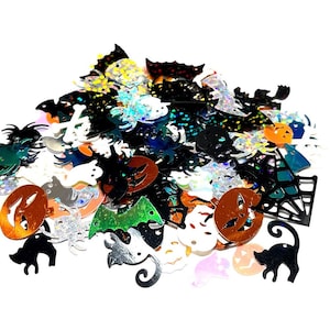 May include: Assortment of Halloween-themed craft supplies, including bats, spiders, pumpkins, ghosts, and more. The shapes are made of iridescent and metallic paper.