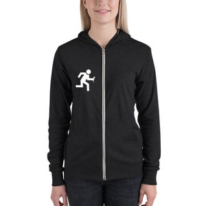 May include: A black zip-up hoodie with a white stick figure running and holding a microphone. The hoodie has a hood and long sleeves.
